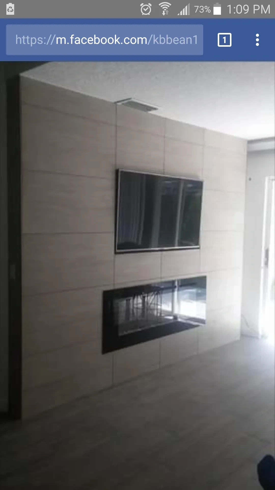 Modern tiled fireplace and TV wall